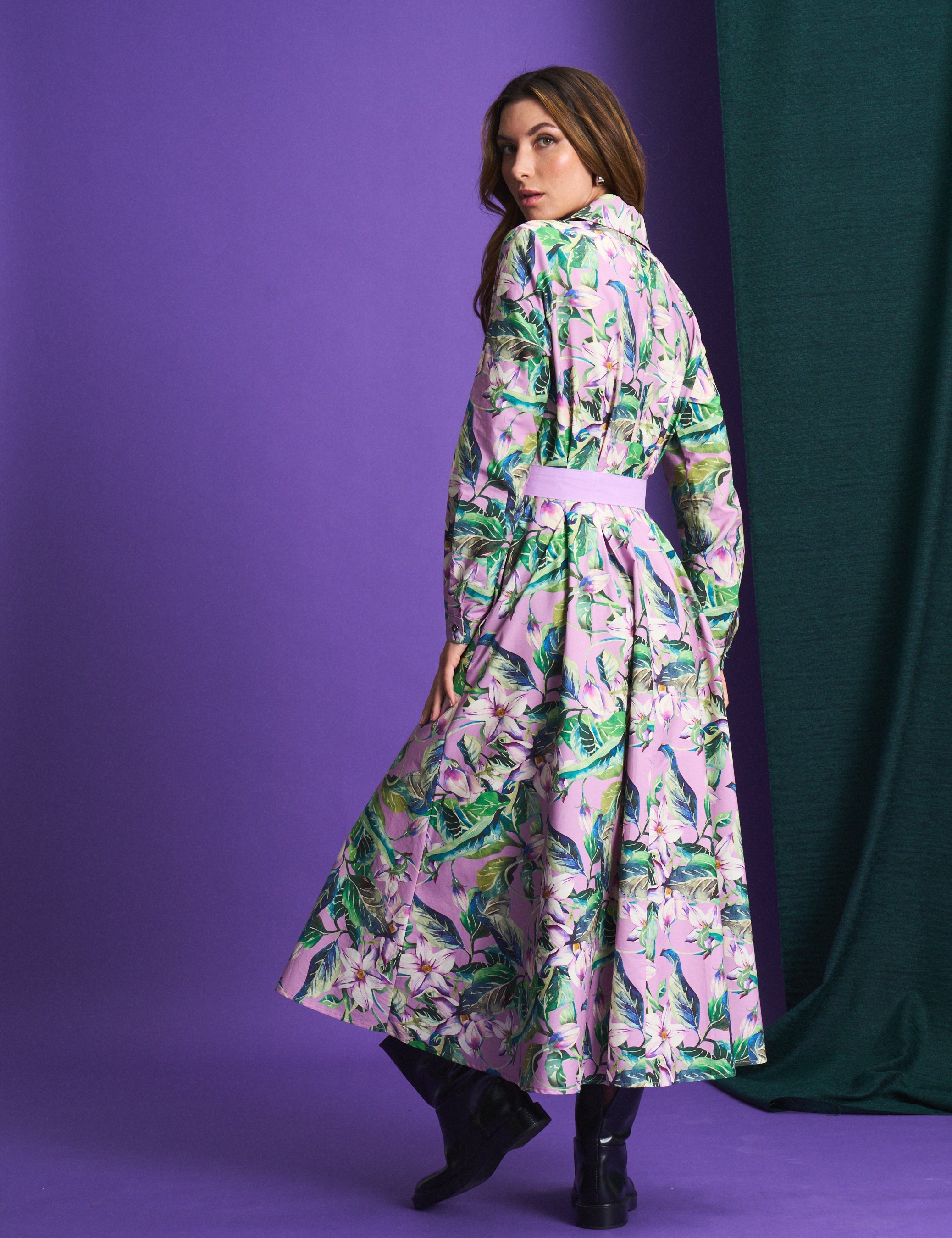 Woman wearing a floral dress against a purple background