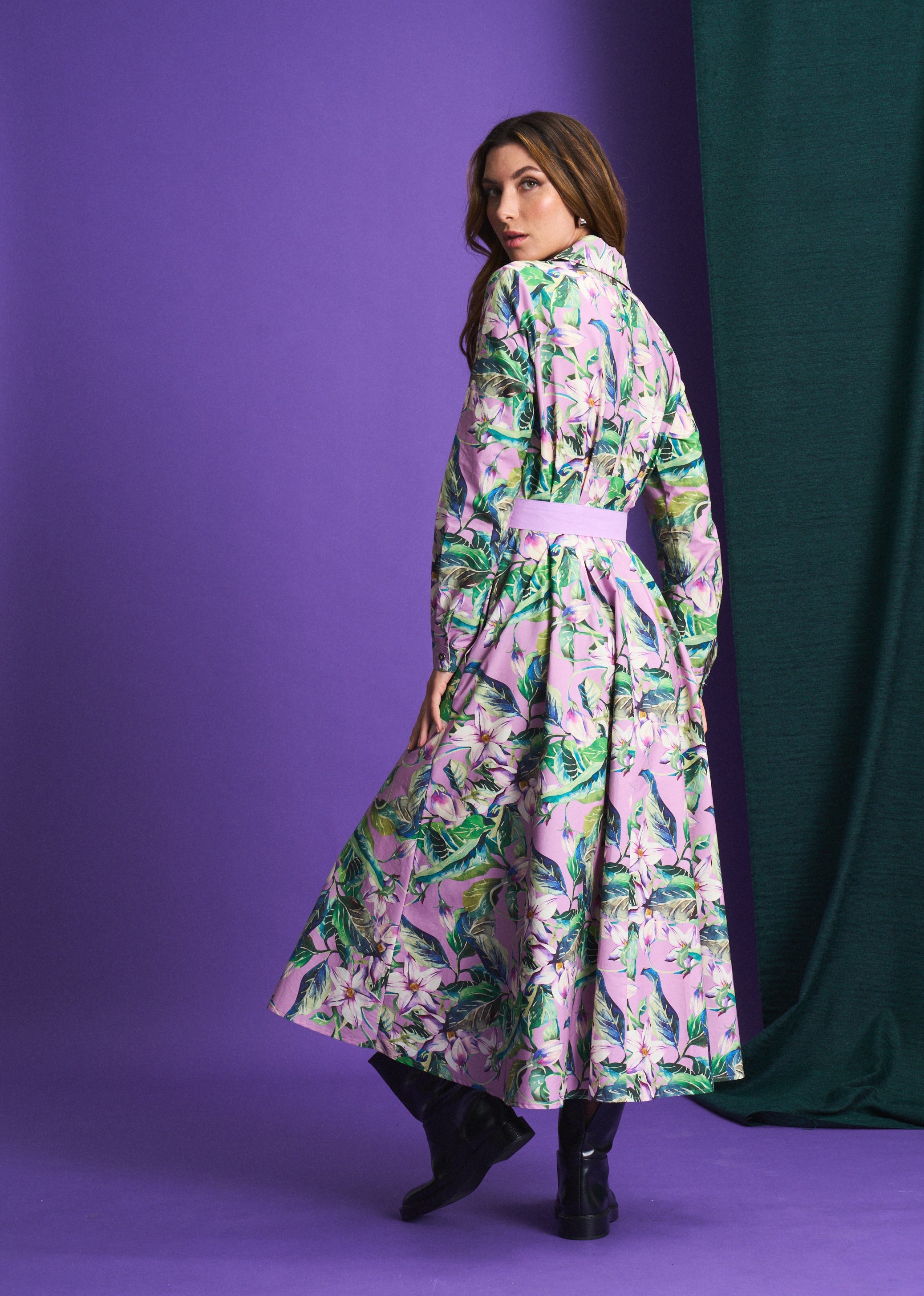 Woman wearing a floral dress against a purple background