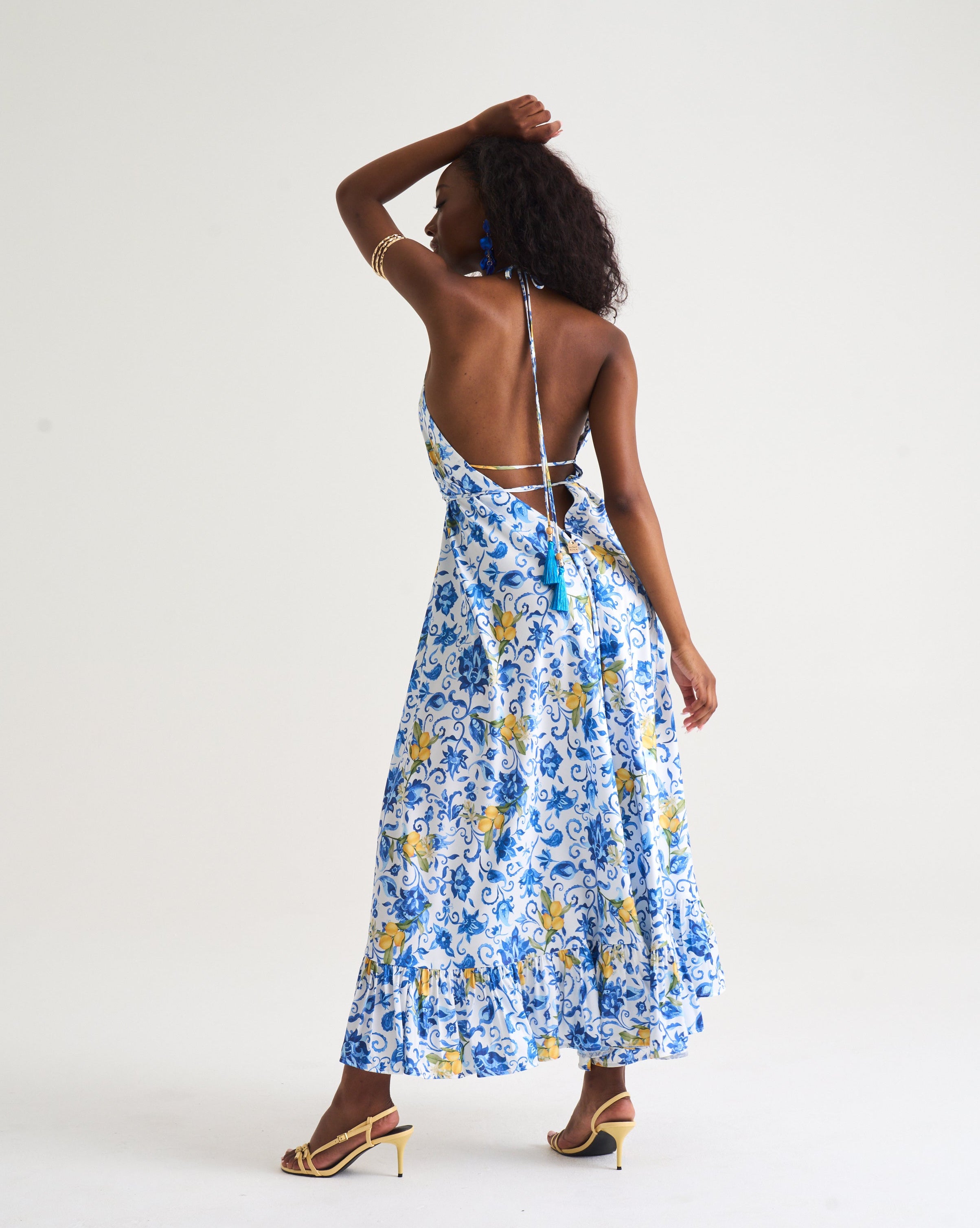 Woman wearing a blue floral dress on a white background